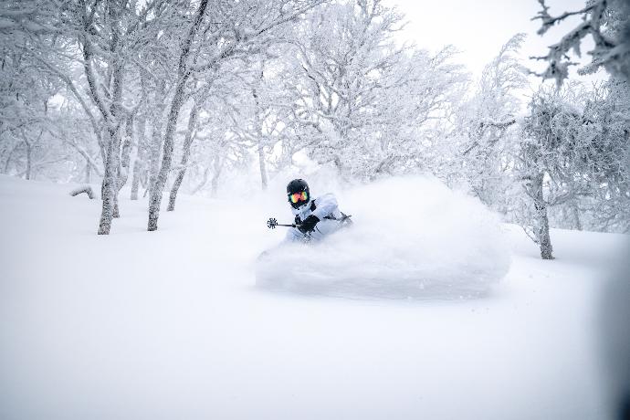 person riding on black motorcycle on snow covered ground during daytime